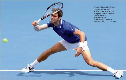  ?? AFP ?? Serbia’s Novak Djokovic returns to Dominic Thiem of Austria at the Kooyong Classic tennis tournament in Melbourne on Wednesday. Djokovic won 6- 1, 6- 4. —