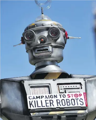  ?? CARL COURT / AFP / GETTY IMAGES FILES ?? A mock “killer robot” in central London in 2013 during the launching of the Campaign to Stop Killer Robots, which calls for the ban of lethal robot weapons.