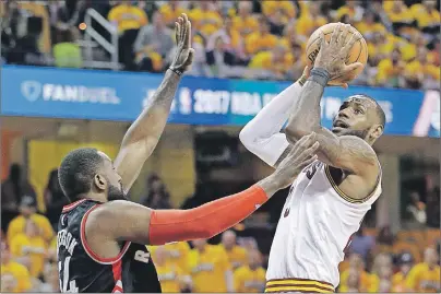  ?? AP PHOTO ?? Cleveland Cavaliers’ LeBron James, right, drives to the basket against Toronto Raptors’ Patrick Patterson (54) in the first half in Game 1 of a second-round NBA basketball playoff series, Monday, in Cleveland.