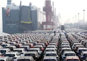  ?? — Reuters ?? Cars for export wait to be loaded onto a cargo vessel at a port in Lianyungan­g, China.