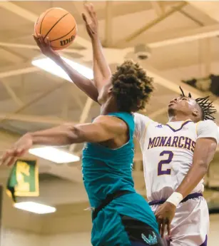  ?? KENDALL WARNER/STAFF ?? Menchville’s AJ Clark goes up for a shot against Woodside during Tuesday night’s game in Newport News. Clark finished with 23 points.