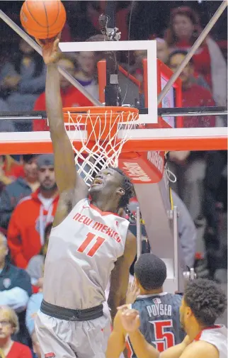  ?? GREG SORBER/JOURNAL ?? UNM senior Obij Aget (11) blocks a UNLV shot during the Lobos’ loss in the Pit Tuesday. New Mexico, which has lost its last three games, visits Colorado State today.