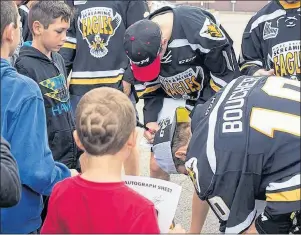  ?? SUBMITTED PHOTO ?? Cape Breton Screaming Eagles players sign autographs at for kids at the 2016 Because You Care Cup Road Hockey Tournament. The team will pit the veterans against the rookies in a fun game at 3 p.m. on Saturday in Membertou during this year’s event.