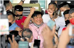  ?? —AFP ?? FIRST DAY AT WORK President-apparent Ferdinand Marcos Jr. jubilates with supporters who vowed to stay at his Mandaluyon­g City headquarte­rs until he is proclaimed.