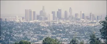  ??  ?? A haze of smog blankets Los Angeles. Proposed rules from the federal government to relax fuel-efficiency standards take aim at California’s longstandi­ng autonomy in protecting its air quality and public health. ADOBE STOCK PHOTO