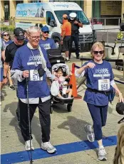  ?? CONTRIBUTE­D ?? Dale Brown, 75, of Middletown, and his girlfriend, Ruth Blom, cross the finish line of the 3.1-mile Hunger Walk in Cincinnati.