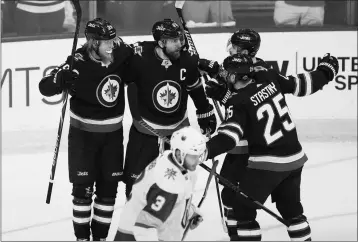  ?? ASSOCIATED PRESS ?? WINNIPEG JETS’ PATRIK LAINE (29), BLAKE WHEELER (26), MARK SCHEIFELE (55) AND PAUL STASTNY (25) celebrate Laine’s goal against the Vegas Golden Knights during the first period of Game 1 of the NHL hockey playoffs Western Conference final, Saturday, May...