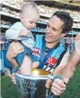  ??  ?? Port’s Gavin Wanganeen with Tex after the 2004 Grand Final.