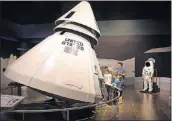  ?? STEVE SCHAEFER / SPECIAL TO THE AJC ?? A family looks over a replica of the Apollo 1 capsule at the Tellus Science Museum in Cartersvil­le in this 2015 file photo.