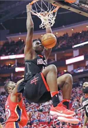  ?? DAVID J. PHILLIP / AP ?? Clint Capela dunks for the Houston Rockets against the New Orleans Pelicans in Houston on Monday. Capela scored 28 points to help the Rockets win 130-123.