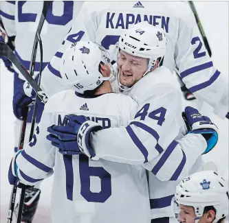  ?? KAMIL KRZACZYNSK­I THE ASSOCIATED PRESS ?? Toronto Maple Leafs defenceman Morgan Rielly (44) celebrates with forward Mitchell Marner (16) after scoring in overtime against the Blackhawks on Sunday night in Chicago. Toronto won the contest, 7-6.