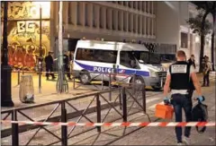  ?? AFP ?? French police attend the scene of a knife attack in Paris late on Sunday in which a man injured seven people.