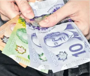  ?? POSTMEDIA NEWS ?? Most Canadians plan to keep cash on hand as the pandemic unfolds.