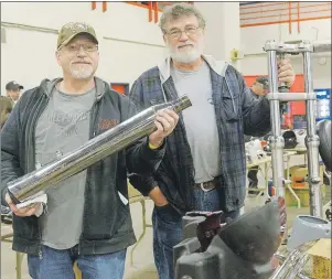  ?? MITCH MACDONALD/THE GUARDIAN ?? Paddy Hachey, left, holds up a motorcycle exhaust while Dennis Gionet, owner of Moore Cycle in Truro, N.S., holds up a front end for a Harley-Davidson during the motorcycle swap meet at EastLink Centre on the weekend. Gionet is a mechanic with a...