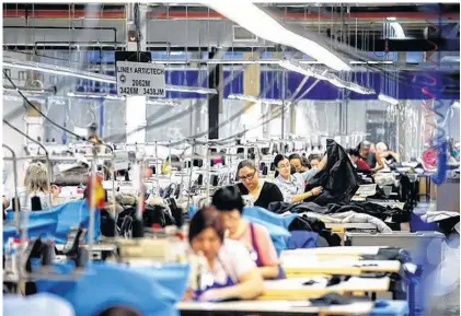 ?? MARK BLINCH/REUTERS ?? Workers make jackets at the Canada Goose factory in Toronto, Ont., Feb. 23, 2018.