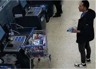 ?? ?? Bottle of water: Suspect Abdul Ezedi in a north London Tesco Express