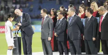  ??  ?? AMMAN: FIFA President Gianni Infantino, second left, awards the silver trophy to Japanese captain Fuka Nagano after the final game against North Korea at the FIFA U-17 Women’s World Cup at Amman Internatio­nal Stadium in Amman, Jordan, Friday. — AP