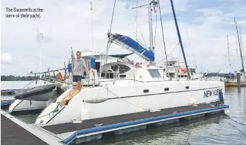  ??  ?? The Swannells at the stern of their yacht.