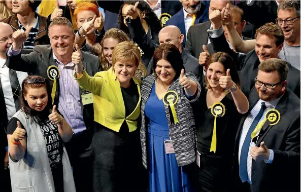  ??  ?? Scotland’s First Minister Nicola Sturgeon and Scottish National Party supporters give the thumbs-up at the counting centre in Glasgow. The SNP lost seven council seats and lost control of Dundee, while the Conservati­ves gained 164 seats as they...