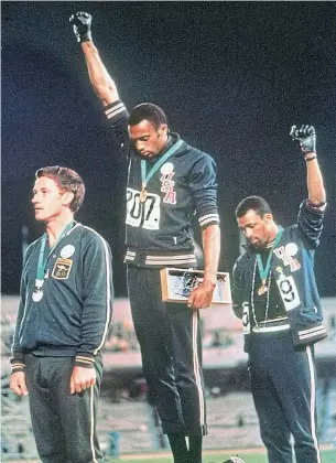  ?? THE ASSOCIATED PRESS ?? U.S. sprinters Tommie Smith, centre, and John Carlos became the symbol of athlete activism when they raised their black-gloved fists for equality at the 1968 Summer Olympics.