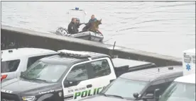  ??  ?? New Milford Police, the state Department of Energy and Environmen­tal Protection and divers from the State Police and Newtown Search and Rescue team search Candlewood Lake off Dike Point on Tuesday for a teen who was reported to have slipped under the water on Monday.