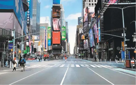  ?? SPENCER PLATT/GETTY IMAGES NORTH AMERICA/TNS ?? Times Square in New York stands mostly empty as as much of the city is void of cars and pedestrian­s amid the coronaviru­s pandemic March 22.