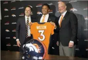  ?? ASSOCIATED PRESS FILE PHOTO ?? Denver Broncos new starting quarterbac­k Russell Wilson, center, is flanked by coach Nathaniel Hackett, right, and general manager George Paton after a news conference March 16 in Englewood, Colo.