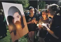  ?? Brian Killian Getty Images ?? A CROWD mourns singer Christina Grimmie after a fan fatally shot her in 2016 at an Orlando, Fla., concert promoted by AEG.