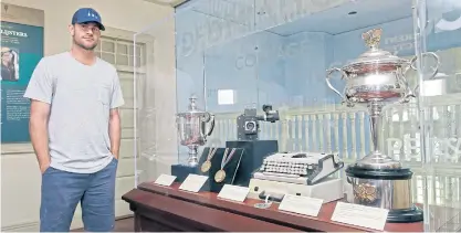  ??  ?? Andy Roddick poses near a display containing his 2003 US Open trophy in the Internatio­nal Hall of Fame Tennis Museum in Newport, Rhode Island.