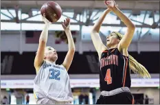  ?? The Washington Post / via Getty Images ?? River Hill Hawks guard Erin Devine (32) attempts a shot over Middletown Knights guard Saylor Poffenbarg­er during the third quarter in March.