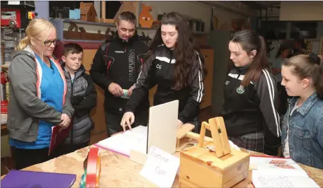  ??  ?? Students Chloe Gallagher and Aoife Smith talking with some of the visitors during the St. Olivers open night.