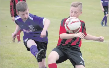  ??  ?? Pressure on: Hillsborou­gh Boys battle with Larne Youths at Templemore Sports Complex