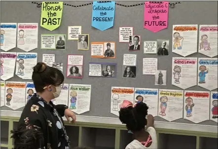  ?? PHOTOS BY KEVIN MARTIN — THE MORNING JOURNAL ?? Kindergart­en students at Hamilton Elementary School in Elyria get a guided tour of student creations March 4as part of the Black History Month Spotlight. Students created projects honoring prominent African Americans throughout the month of February.