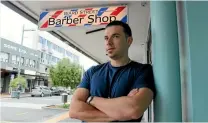  ??  ?? Ward Street Barber Shop owner Willian Victorino Medeiros won’t be changing his store’s name even if the street name change goes ahead.