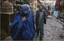  ?? Hector Retamal/AFP / TNS file photo ?? An Afghan burqa-clad woman walks in a market where birds are sold in Kabul on Oct. 31, 2021. The Taliban-led government has again ordered women to wear a burqa in public areas and government institutio­ns.