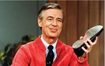  ?? GENE J. PUSKAR/THE ASSOCIATED PRESS FILE PHOTO ?? Fred Rogers rehearses the opening of his PBS show Mister Rogers’ Neighborho­od in Pittsburgh in 1989.