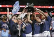  ?? JULIE JACOBSON — THE ASSOCIATED PRESS ?? Virginia players celebrate with the championsh­ip trophy after defeating North Carolina 1in the NCAA Atlantic Coast Conference men’s college basketball tournament, Saturday in New York.