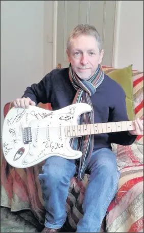  ??  ?? Leicesters­hire-based music promoter David Allen has been reunited with a Fender Stratocast­er guitar that was lost in transit 10 years ago after being signed by musical greats including Eric Clapton, Brian May and Jimmy Page. Mr Allen hopes to add more...