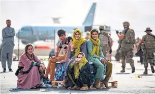  ?? MARK ANDRIES U.S. MARINE CORPS/AFP VIA GETTY IMAGES ?? Evacuee children wait for the next U.S. rescue flight in Kabul on Thursday. A Canadian flight evacuated 106 Afghan refugees on Friday, with more flights planned as soon as possible.