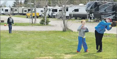  ?? NIKKI SULLIVAN/CAPE BRETON POST ?? Brady Eagles, 7, throws the ball to his brother Tristen, 11, and friend Drake Deveaux, 10, at the Lakeview Campground in Catalone.