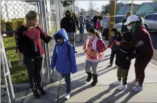  ?? MARCIO JOSE SANCHEZ — THE ASSOCIATED PRESS ?? Assistant principal Janette Van Gelderen on Thursday welcomes students at Newhall Elementary in Santa Clarita, Calif. The state’s public schools could get $6.6billion from the legislatur­e if they return to in-person instructio­n by the end of March, according to a new agreement announced Monday.