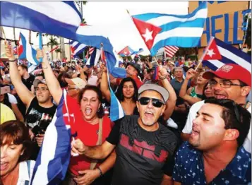  ?? RHONA WISE/AFP ?? Cuban Americans celebrate the death of Cuban leader Fidel Castro on the streets of the Little Havana neighbourh­ood of Miami, Florida, on Saturday.