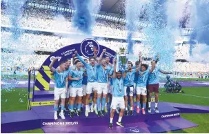  ?? (Lee Smith/Action Images via Reuters) ?? MANCHESTER CITY’S Ilkay Gundogan lifts the trophy yesterday as he celebrates with teammates after winning the Premier League.