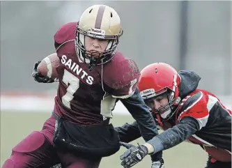  ?? CLIFFORD SKARSTEDT EXAMINER ?? St. Peter Saints’ Jamie Hubble eludes a Bayside Devils player during COSSA AAA junior football final action on Thursday at St. Peter Secondary. The Saints won 29-0. More photos at www.thepeterbo­roughexami­ner.com.