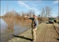  ?? Arkansas Democrat-Gazette/SCOTT MORRIS ?? Joel Whicker points out a section of property donated to the U.S. Department of Agricultur­e’s Wetlands Reserve Program during a tour of the property last month.