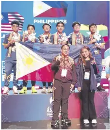  ?? ?? Sibol members are shown at the winner’s podium with Cavite Vice Gov. Athena Tolentino.