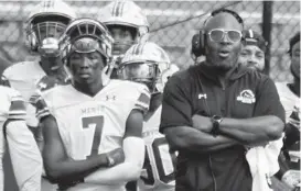  ?? BARBARA HADDOCK TAYLOR/BALTIMORE SUN MEDIA ?? Mervo football player Elijah Gorham, left, stands next to coach Patrick Nixon, right, on the sideline during a game against Dunbar at Baltimore Polytechni­c stadium on Sept. 18.