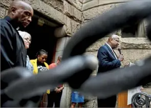  ?? Post-Gazette ?? The Rev. Richard Freeman, president of the Pennsylvan­ia Interfaith Impact Network, leads a prayer outside the Allegheny County Courthouse during a service in response to the deaths since March 2020 at the Allegheny County Jail on Sep. 1, Downtown.