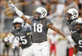  ?? STEPHEN M. DOWELL / ORLANDO SENTINEL ?? UCF linebacker Shaquem Griffin (18) celebrates after returning a fumble for a TD in the Knights’ 73-33 rout of Austin Peay last week.