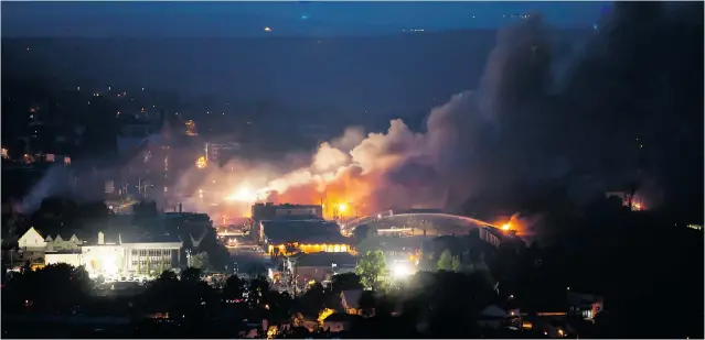  ?? FRANCOIS LAPLANTE- DELAGRAVE/ AFP/ GETTY IMAGES FILES ?? Firefighte­rs douse blazes after a runaway train loaded with oil derailed in Lac- Mégantic on June 6, 2013. An unsealed police warrant reveals there was a fire in one of the engines earlier that night.